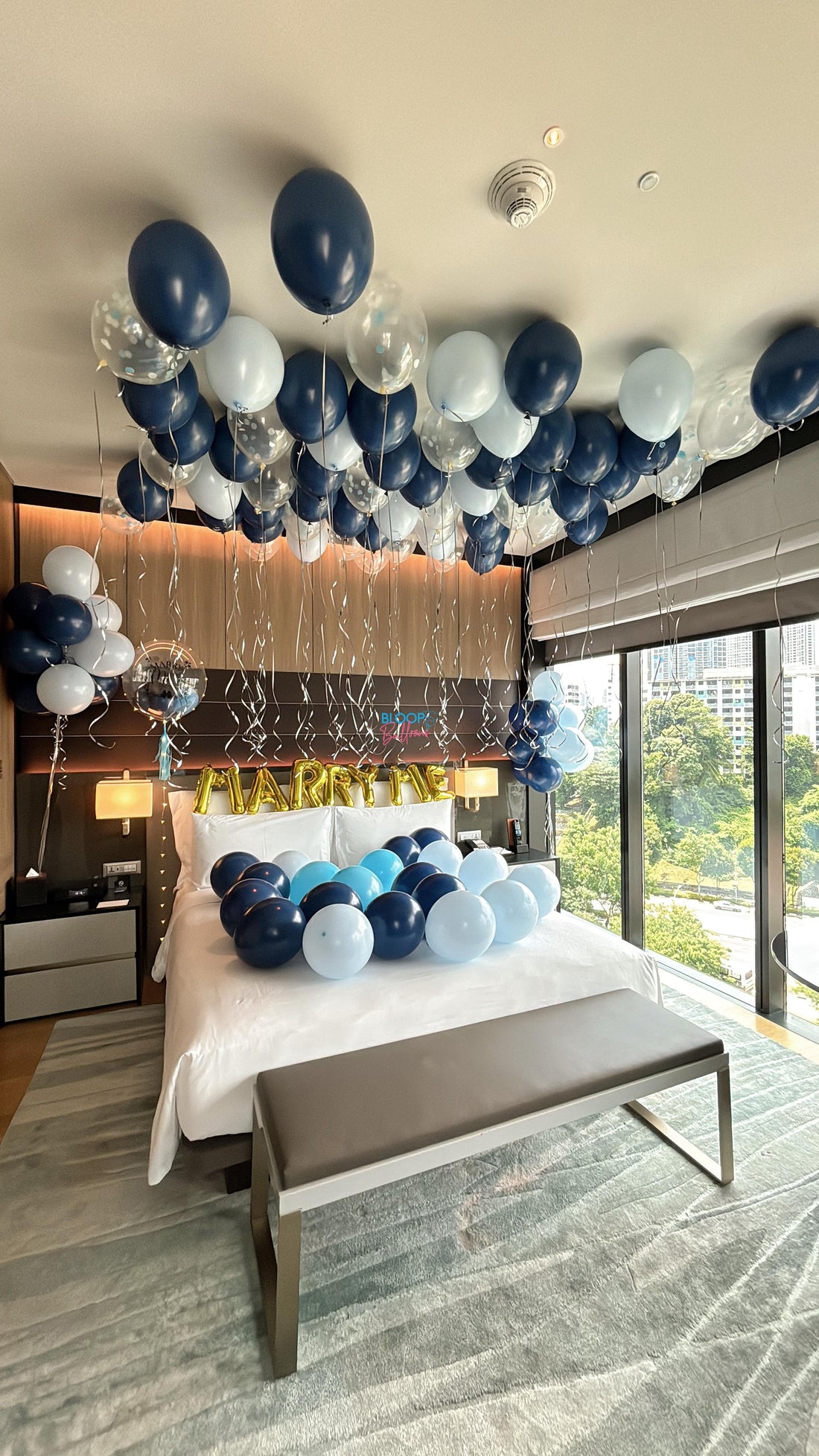 Luxury navy blue and light blue hotel room proposal decoration in Singapore with balloons, romantic styling and elegant setup
