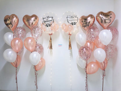 Decorative balloons with heart shapes and text on a white background