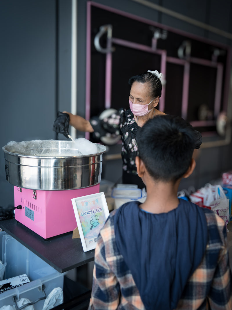 Children enjoying candy floss fringe activity at a birthday party event