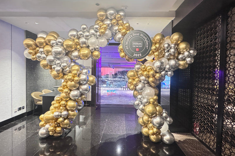 Elegant chrome gold and chrome silver balloon display at Hilton Hotel Singapore event