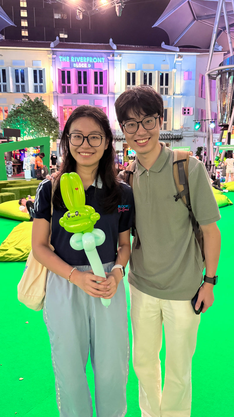 Green themed rabbit wand balloon sculpting at StarHub event in Singapore by Bloop Balloons