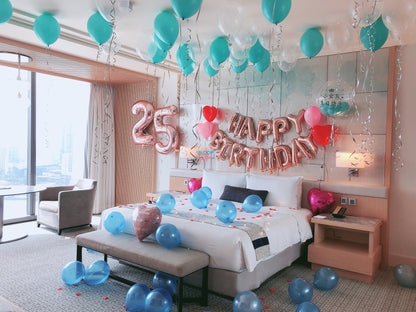 Decorated bedroom with balloons and 'Happy Birthday' and '25' balloons.