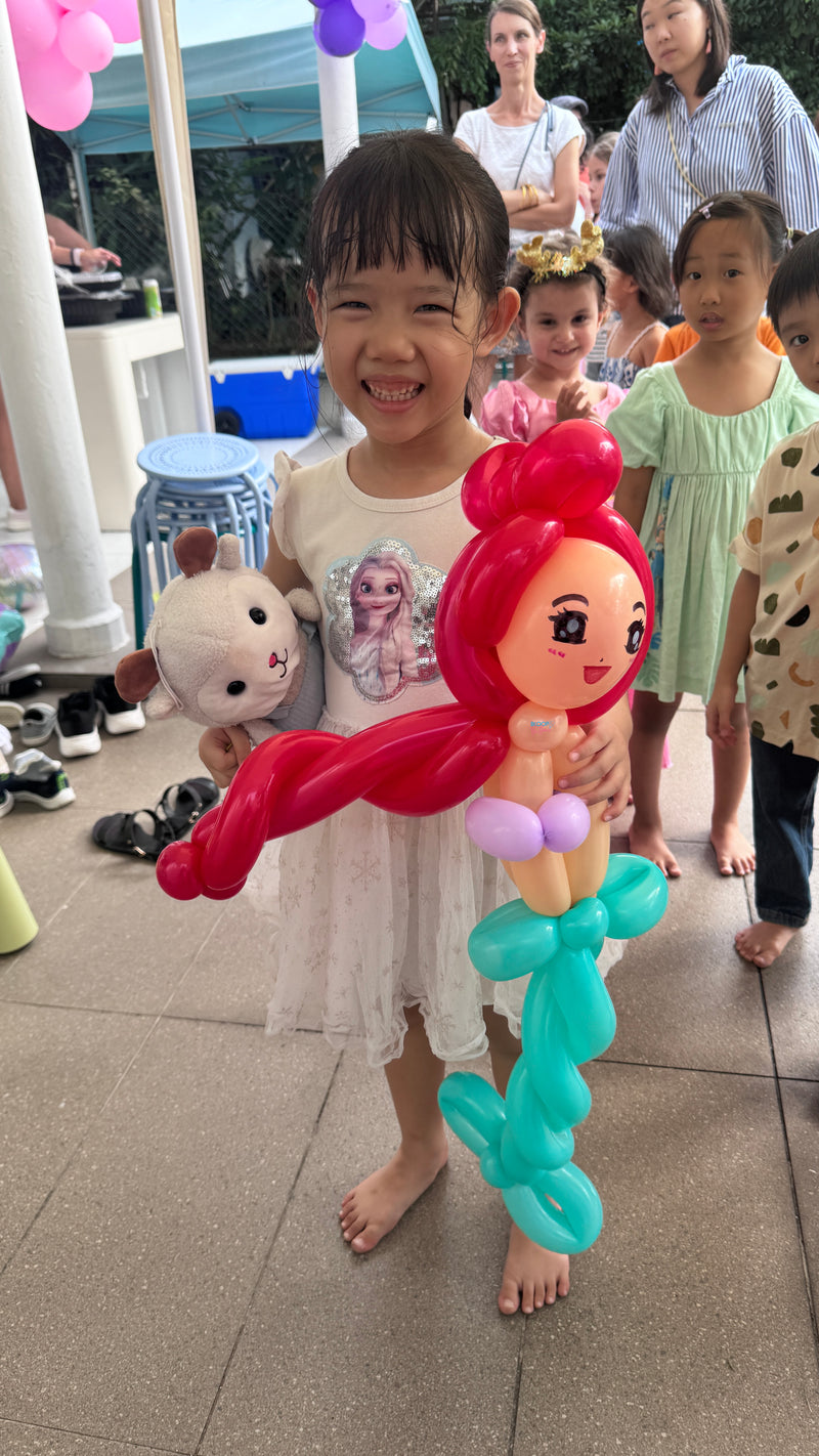 Mermaid balloon sculpting for children at a birthday party event in Singapore