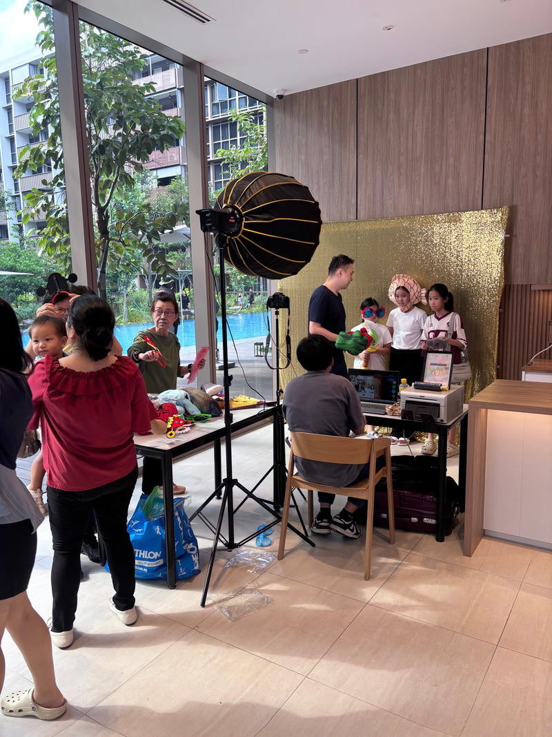 Photobooth setup with gold backdrop at Pasir Ris 8 condo event in Singapore