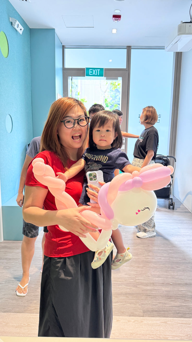Balloon artist creating unicorn balloon sculptures for Pasir Ris 8 condominium Chinese New Year celebration