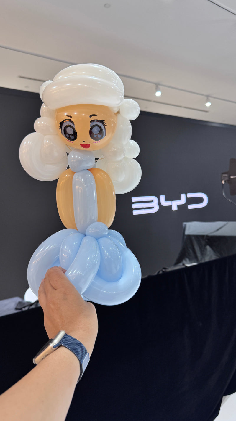 Balloon artist making Princess Elsa balloon sculpting for children at BYD corporate event