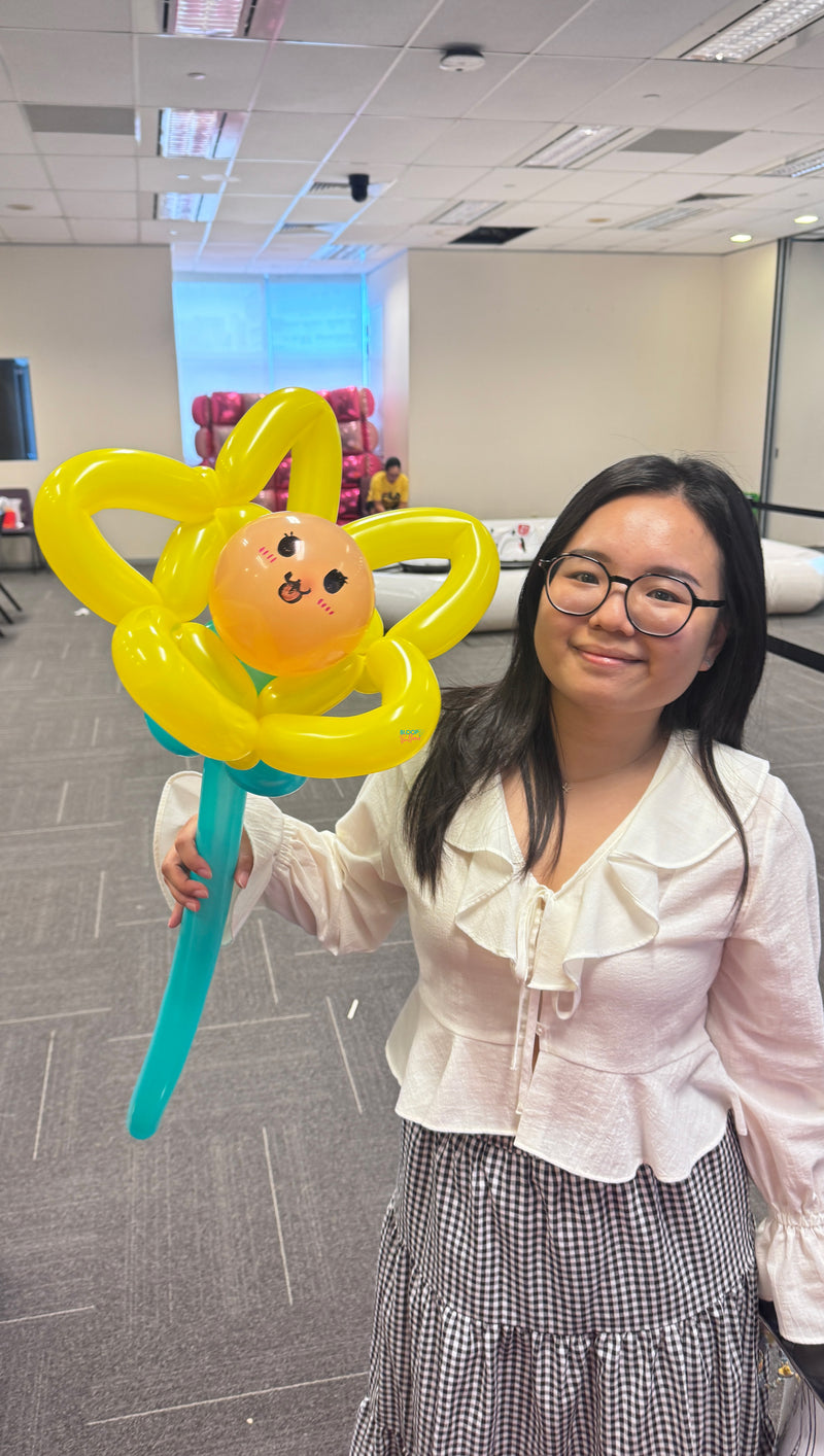 Sunflower balloon sculpting at AIA bring your kids to work event in Singapore by Bloop Balloons