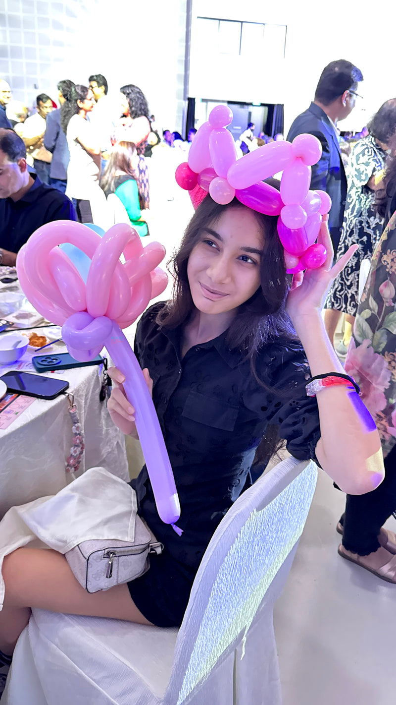 Tiara and flower balloon sculpting for corporate event in Singapore by Bloop Balloons